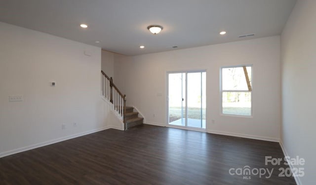 unfurnished room featuring visible vents, dark wood finished floors, recessed lighting, stairway, and baseboards