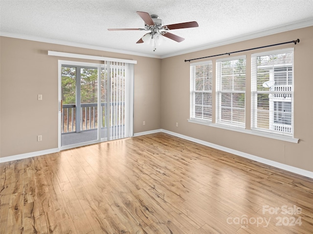 empty room with ceiling fan, light hardwood / wood-style floors, ornamental molding, and a textured ceiling