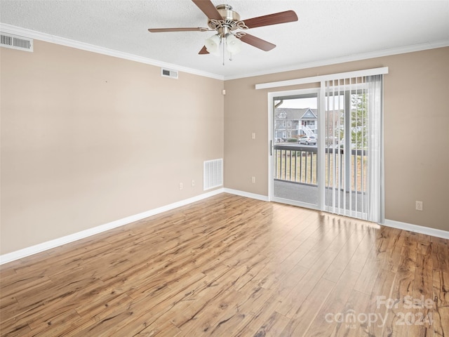 empty room with ceiling fan, light hardwood / wood-style floors, ornamental molding, and a textured ceiling