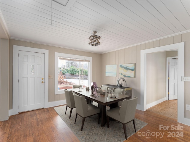 dining room featuring ornamental molding, wood ceiling, and hardwood / wood-style flooring