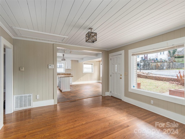 interior space featuring hardwood / wood-style floors, wooden walls, plenty of natural light, and wooden ceiling