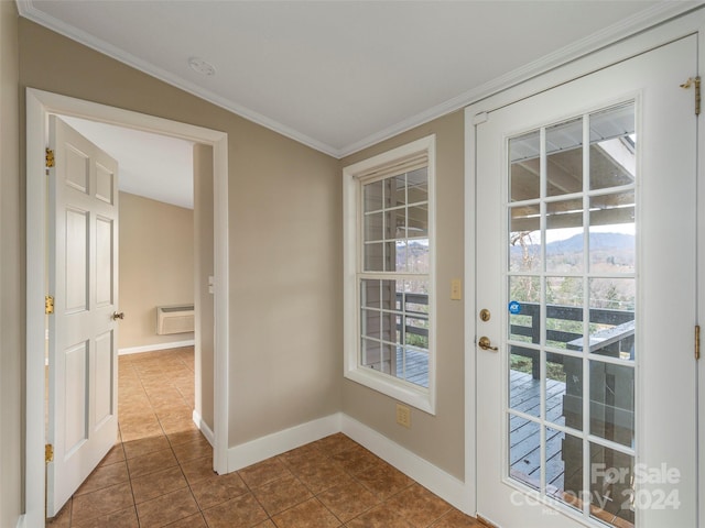 doorway to outside featuring crown molding and tile patterned flooring