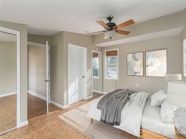 bedroom with ceiling fan and light tile patterned floors