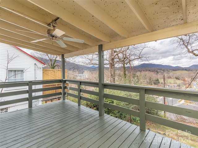 wooden deck featuring a mountain view and ceiling fan