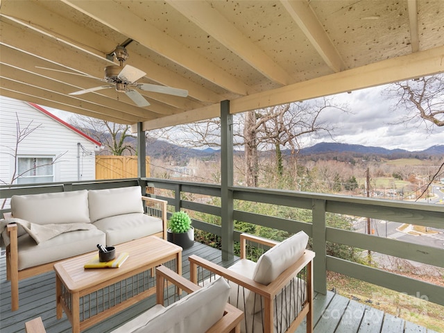 wooden deck with a mountain view, an outdoor hangout area, and ceiling fan