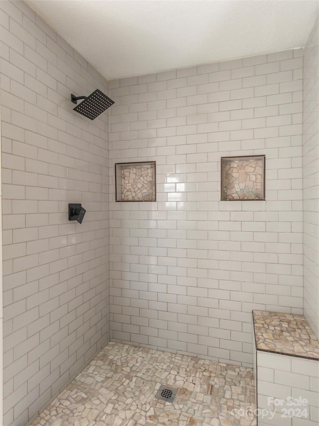 bathroom featuring a tile shower