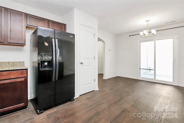 kitchen with dark hardwood / wood-style flooring, black fridge, dark brown cabinets, a chandelier, and hanging light fixtures