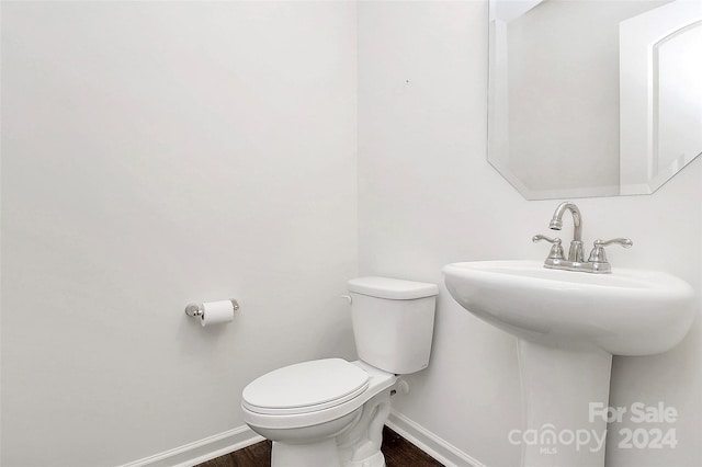 bathroom with wood-type flooring and toilet