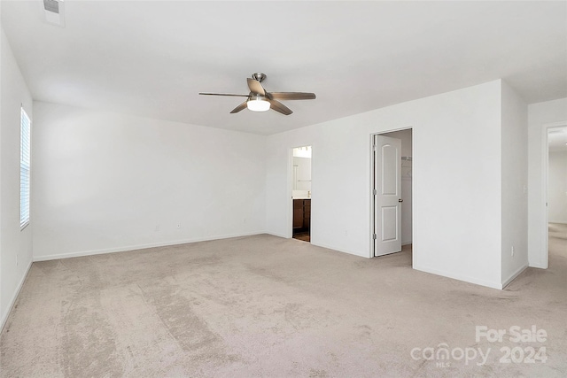 unfurnished room featuring light colored carpet and ceiling fan