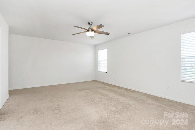 carpeted empty room with ceiling fan