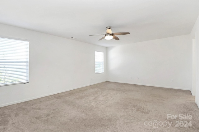 carpeted empty room with ceiling fan