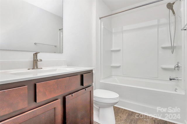 full bathroom with vanity,  shower combination, toilet, and wood-type flooring