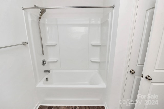 bathroom with wood-type flooring and shower / washtub combination