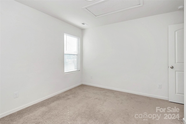 unfurnished room with light carpet