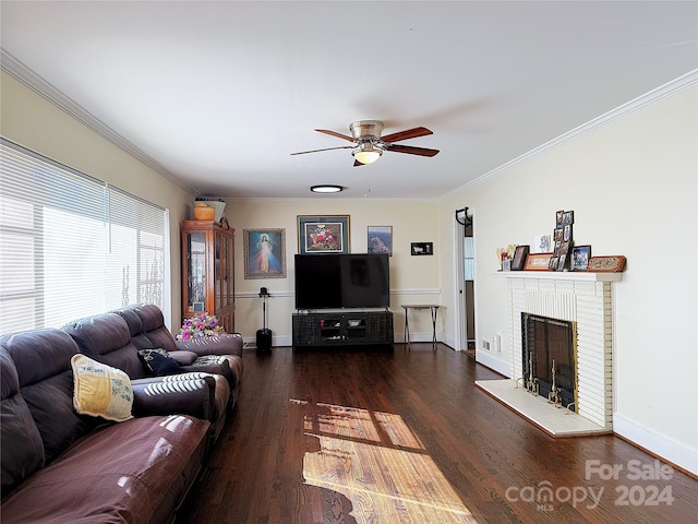 living room with crown molding, ceiling fan, dark hardwood / wood-style floors, and a brick fireplace