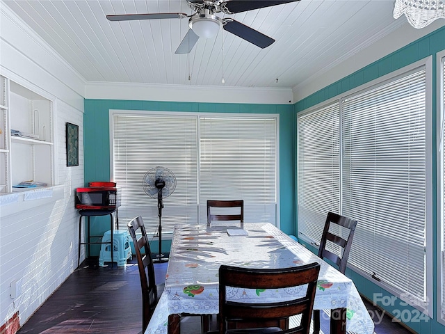 dining space with ceiling fan, ornamental molding, dark wood-type flooring, and wood ceiling