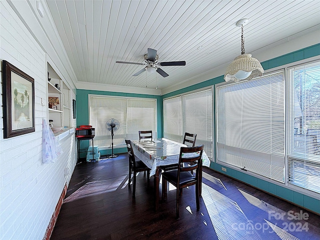 dining area featuring ceiling fan, wooden ceiling, dark wood-type flooring, and brick wall