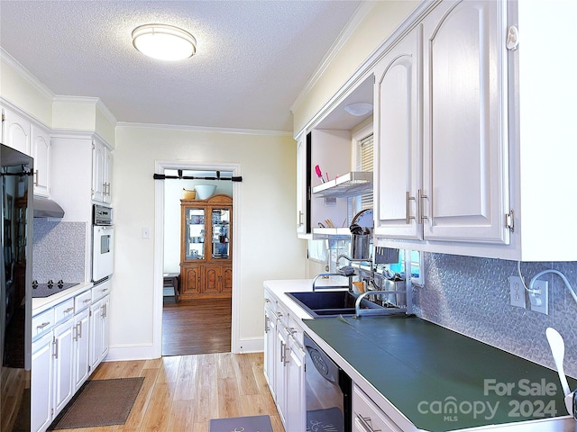 kitchen with black appliances, light wood-type flooring, a textured ceiling, tasteful backsplash, and white cabinetry