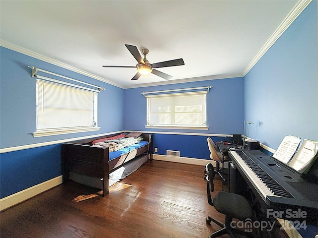 bedroom with ornamental molding, multiple windows, dark wood-type flooring, and ceiling fan