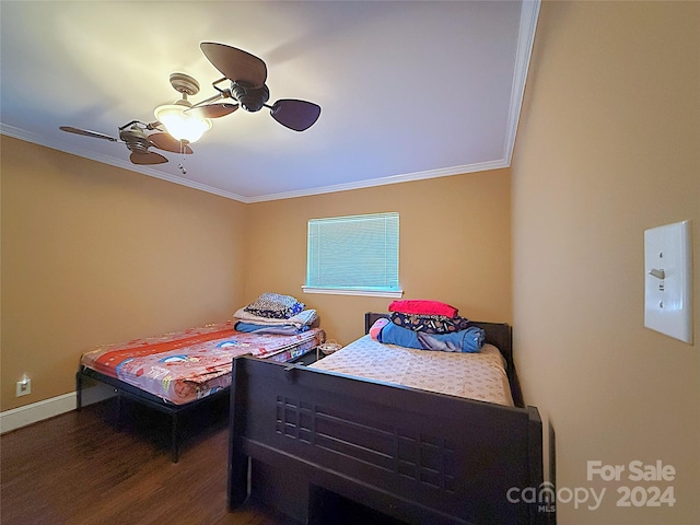 bedroom featuring ceiling fan, crown molding, and dark wood-type flooring