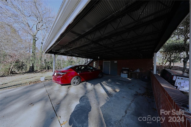 view of parking / parking lot featuring a carport