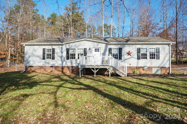 view of front of home featuring a deck and a front lawn