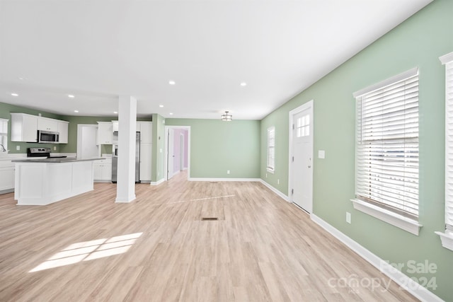 unfurnished living room featuring light hardwood / wood-style flooring