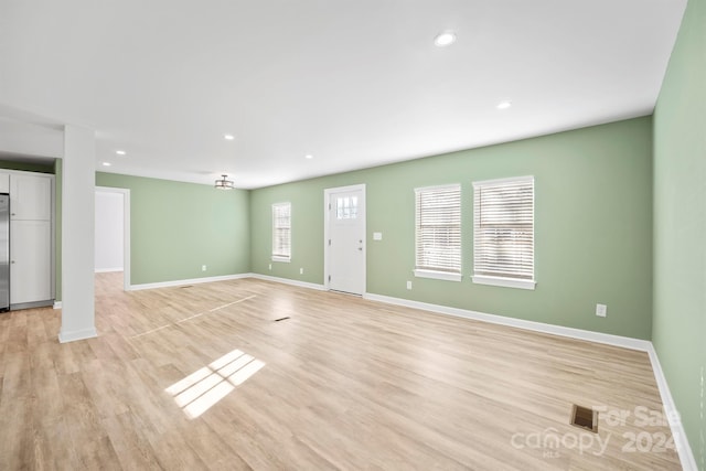 unfurnished living room with light hardwood / wood-style flooring