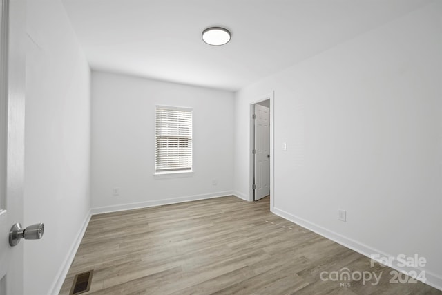 unfurnished room with light wood-type flooring