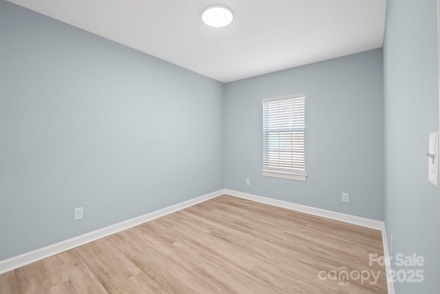 unfurnished room with light wood-type flooring