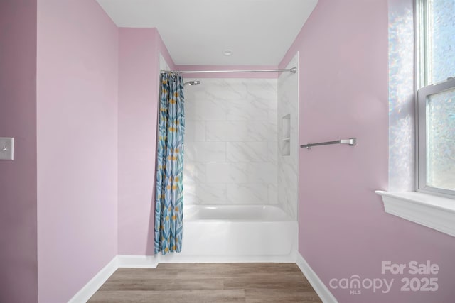 bathroom with shower / tub combo and hardwood / wood-style floors