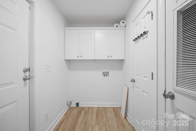 clothes washing area with cabinets, washer hookup, and light hardwood / wood-style floors