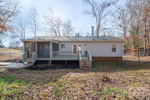 back of property with french doors, a deck, and a sunroom