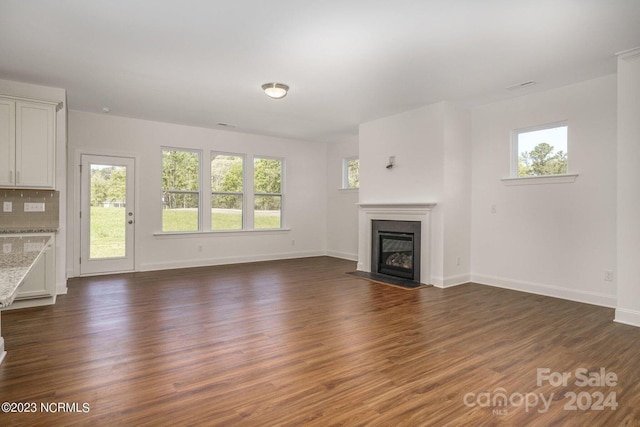 unfurnished living room with dark hardwood / wood-style floors