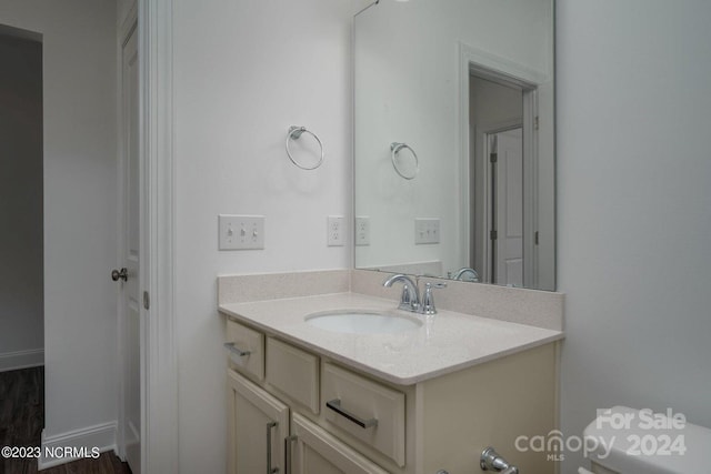 bathroom featuring hardwood / wood-style floors, vanity, and toilet