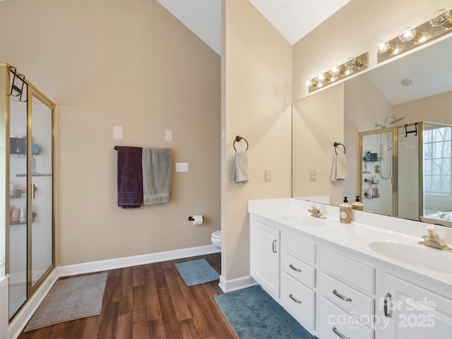 bathroom with lofted ceiling, toilet, an enclosed shower, vanity, and hardwood / wood-style floors