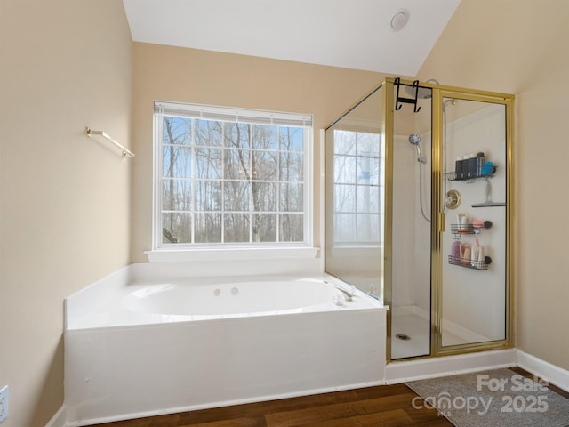 bathroom featuring hardwood / wood-style flooring, vaulted ceiling, and separate shower and tub