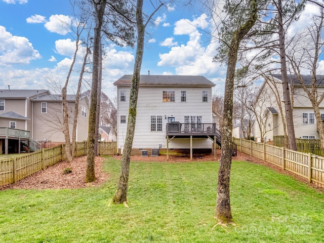 back of property featuring a wooden deck, a yard, and central AC unit