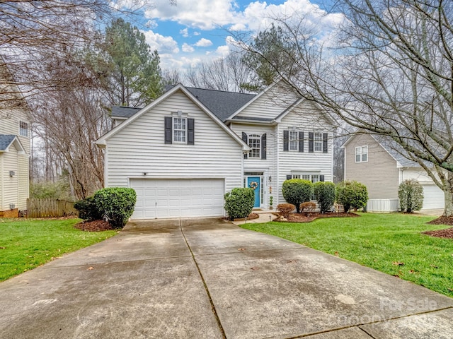 view of property featuring a garage and a front lawn