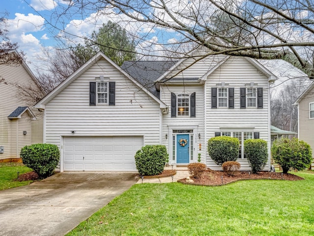 view of property with a garage and a front yard