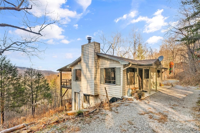 view of side of property featuring a patio area and a mountain view