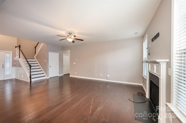 unfurnished living room with dark hardwood / wood-style floors and ceiling fan