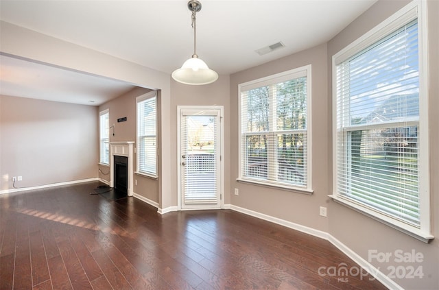 unfurnished living room featuring dark hardwood / wood-style floors