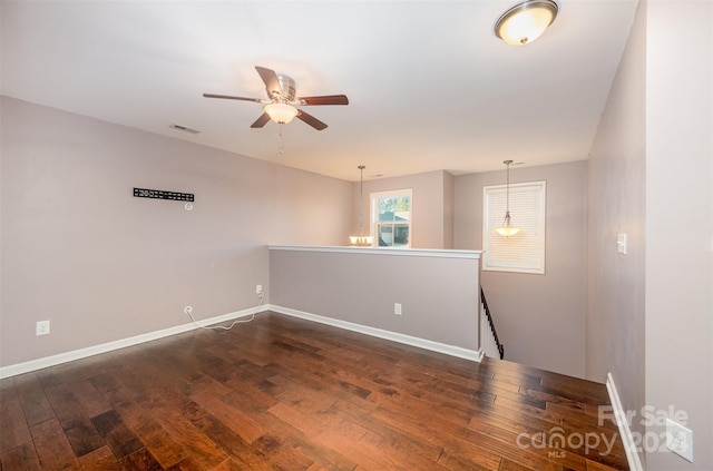 spare room with ceiling fan and dark wood-type flooring