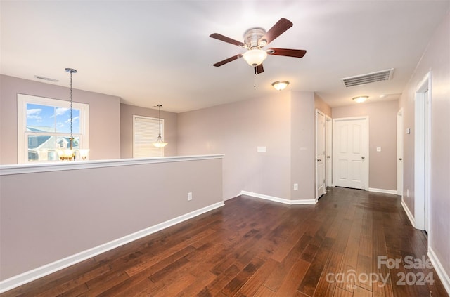 spare room with ceiling fan and dark hardwood / wood-style flooring