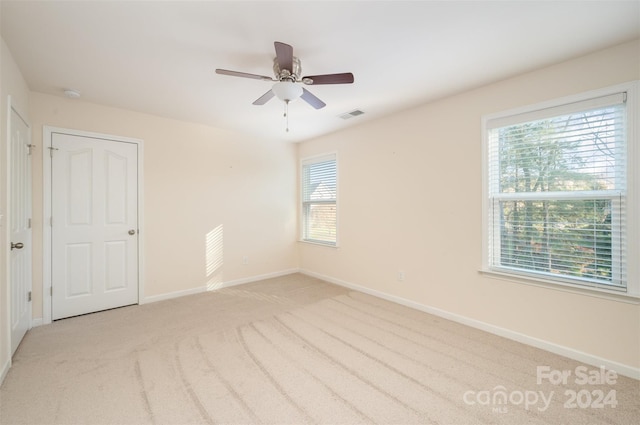 empty room featuring light carpet and ceiling fan