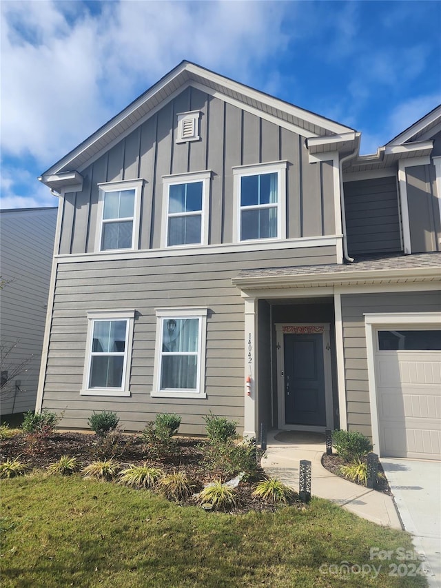 view of front of house featuring a front yard and a garage