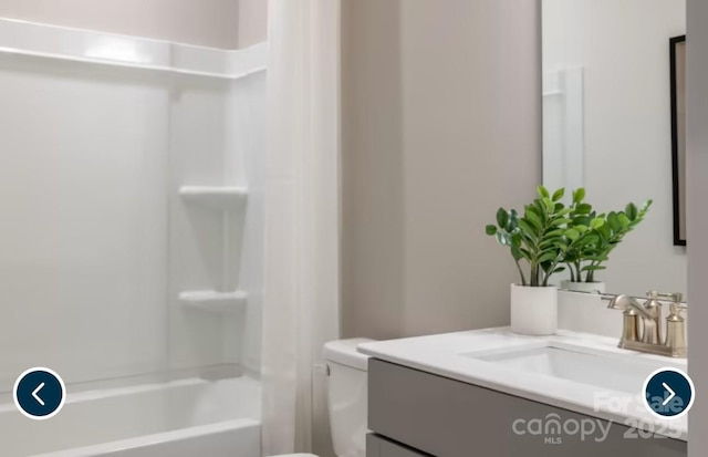 full bathroom featuring toilet, shower / bathtub combination, and vanity