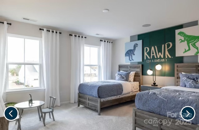 bedroom with visible vents and carpet flooring