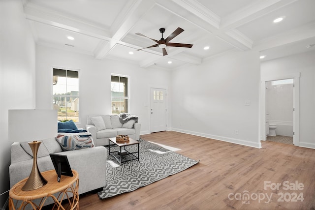 living room with coffered ceiling, hardwood / wood-style flooring, ceiling fan, ornamental molding, and beam ceiling